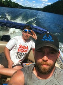 Photo of Adam driving a boat